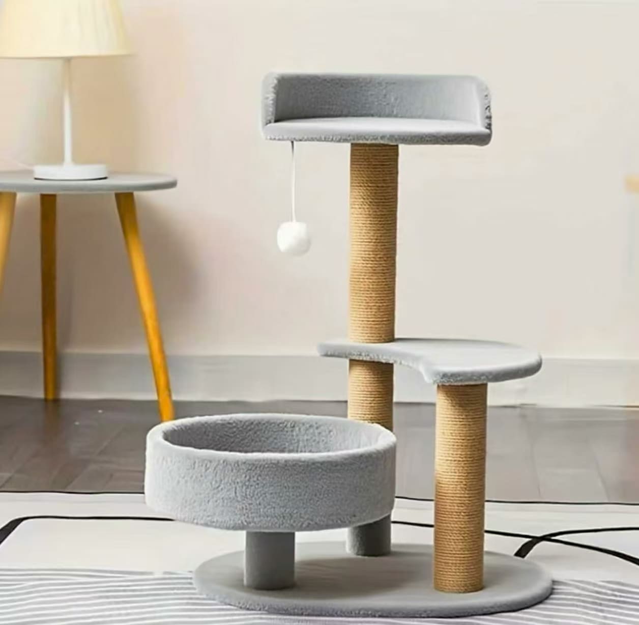 Multi-tiered cat tree with scratching posts and interactive ball toy - perfect indoor cat furniture for play and rest