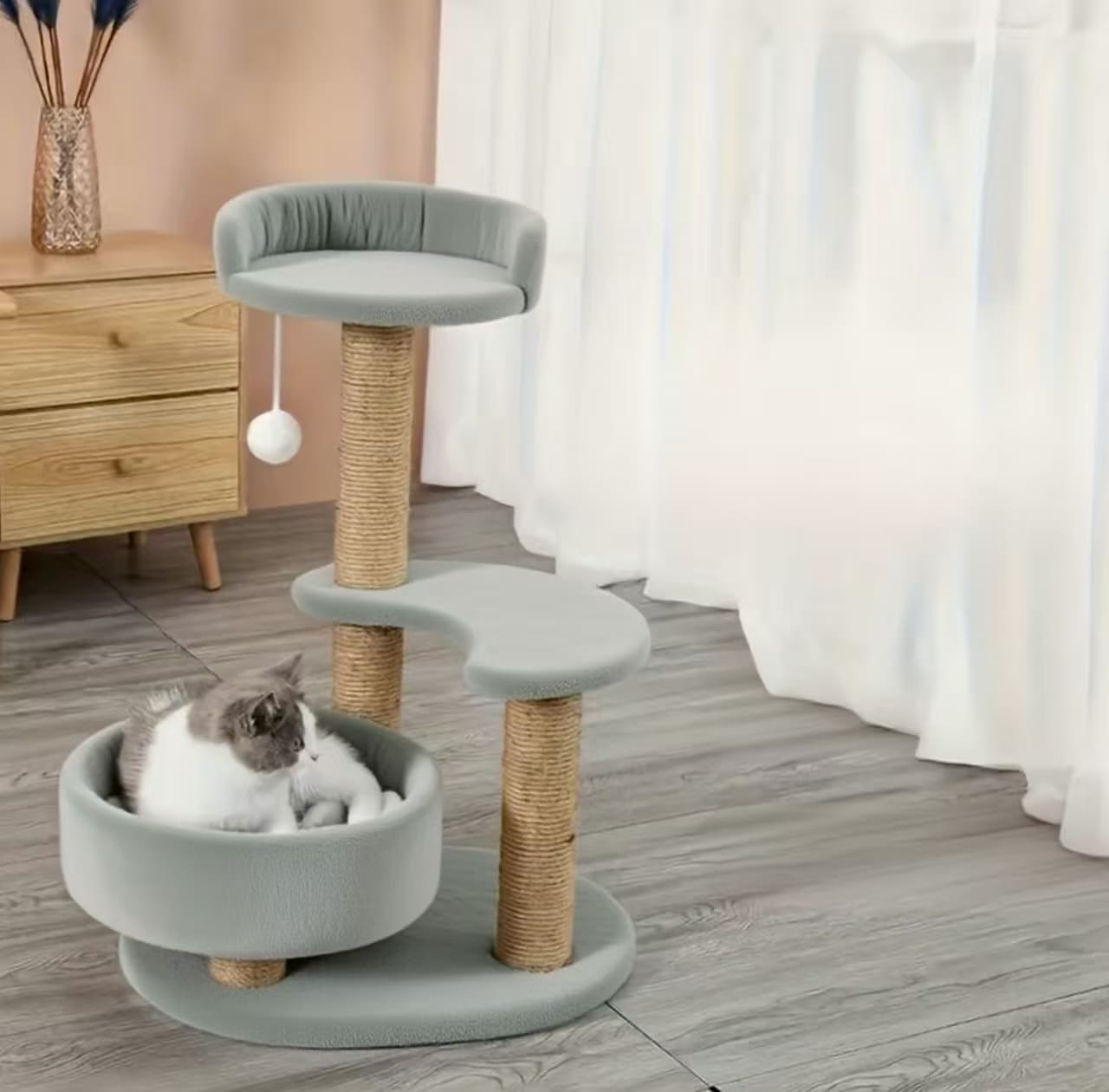 Multi-tiered cat tree with scratching posts and interactive ball toy - perfect indoor cat furniture for play and rest